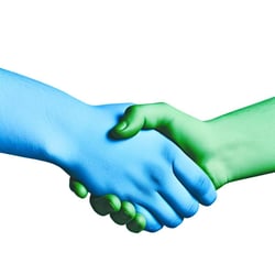 a windows blue hand shaking a light shamrock green hand